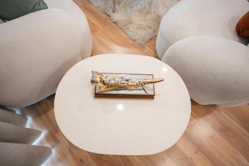 a gold chopsticks on a table in front of white spheres at AR Suites KLJ Square in Gurgaon