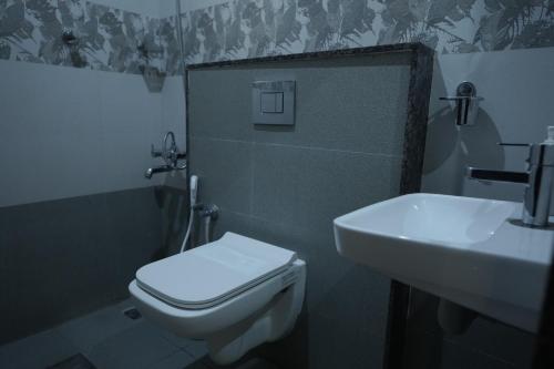 a bathroom with a toilet and a sink at Kalgadde in Chikmagalūr
