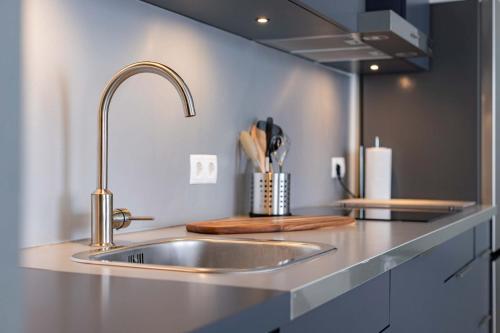 a kitchen counter with a stainless steel sink at Appartement La Costa - Gasselte in Gasselte