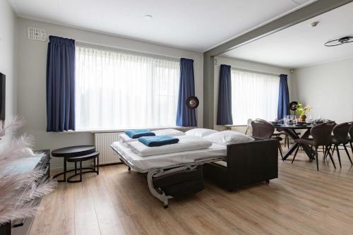 a bedroom with a bed and a dining room at Appartement La Costa - Gasselte in Gasselte