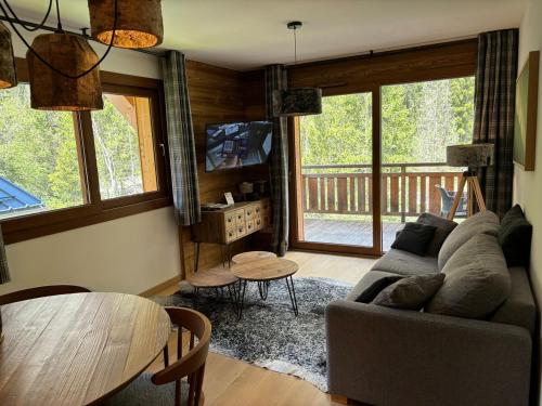 un salon avec un canapé et une table dans l'établissement Les 3 sophies, à Morzine