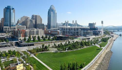 a view of a city with a river and buildings at The 513 Flat-1BR, 1 Bath Apmt with Pool and Riverfront View Only Steps from The banks & Stadiums in Cincinnati