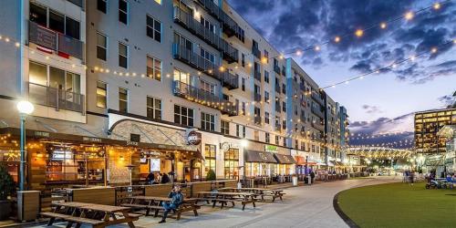 a city street with tables and benches and buildings at The 513 Flat-1BR, 1 Bath Apmt with Pool and Riverfront View Only Steps from The banks & Stadiums in Cincinnati