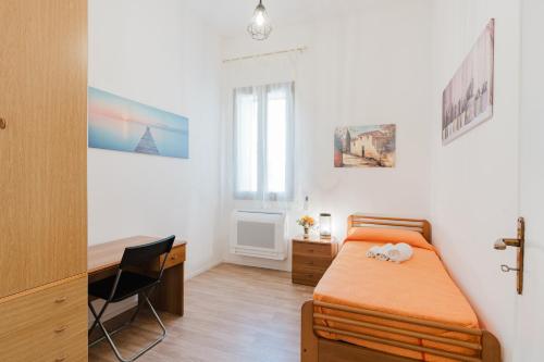 a bedroom with a bed and a desk in it at La Vanedda in Partanna