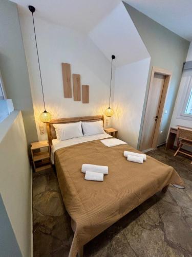 a bedroom with a bed with two towels on it at Haus Viktoria 4 in Limenas