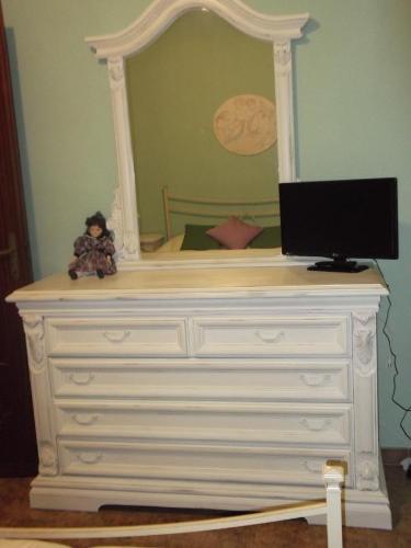 a white dresser with a tv on top of it at Bargoncello in Riccò del Golfo di Spezia