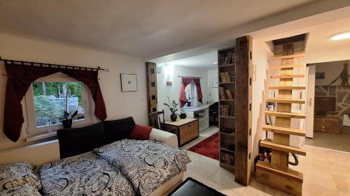 a living room with a couch and a book shelf at Divine Lake House in Motnik