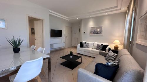 a living room with a couch and a table at Residence Lungomare - Charming apartments in Riccione
