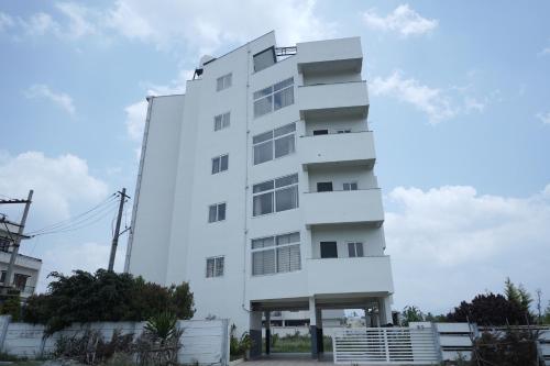 a white building with windows on the side of it at Kalgadde in Chikmagalūr