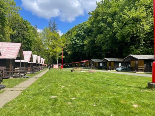 a park with many wooden cabins and green grass at ATC Kemp Kajlovec in Hradec nad Moravici