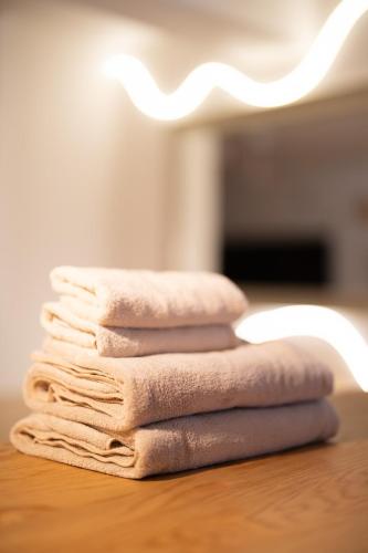 a stack of towels sitting on a table at Liminal Retreats NAGOYA in Nagoya