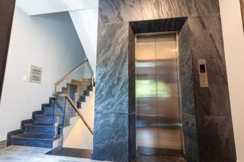 a elevator in a building with blue stairs at Brand New Cozy Home in D1 wBalcony in Ho Chi Minh City