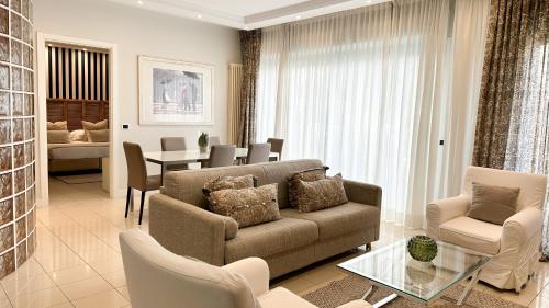 a living room with a couch and a table at Residence Lungomare - Charming apartments in Riccione