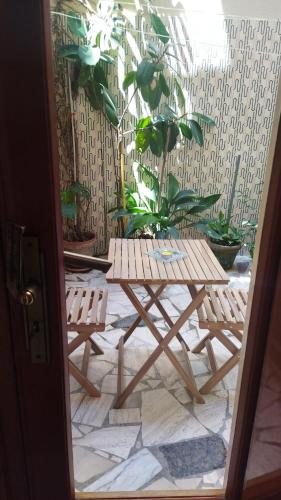 a wooden table and two chairs on a patio at Casa Cucchiara in Grottaglie