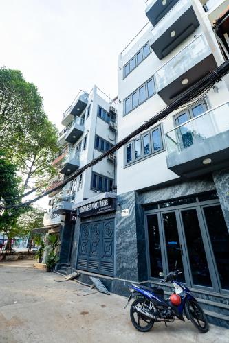 a motorcycle parked in front of a building at Brand New Cozy Home in D1 wBalcony in Ho Chi Minh City