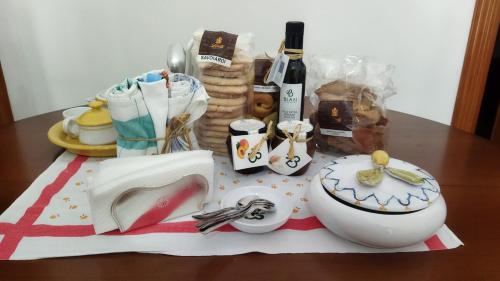 a table with a plate and a bowl and a bottle of wine at Casa Cucchiara in Grottaglie