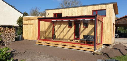 a wooden shed with a chair in the middle at Tiny Frida in Gifhorn