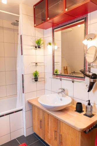 a bathroom with a sink and a mirror at anderswo - Urlaub im Allgäu in Leutkirch im Allgäu