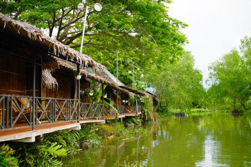 a house with a bridge over a river at Hometravel Mekong Can Tho in Can Tho