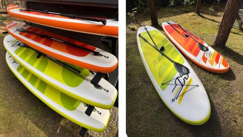 two kayaks are stacked on top of each other at Las Biala's - Domki z sauną i jacuzzi w Puszczy Noteckiej - Tylko dla dorosłych in Biala