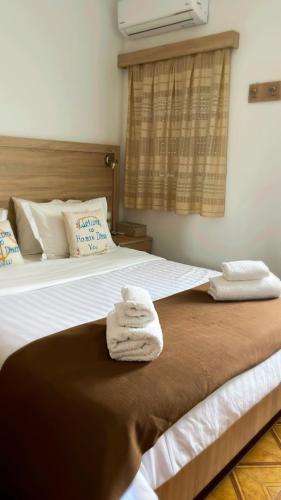 a hotel room with two towels on a bed at Haraki Dream View in Haraki