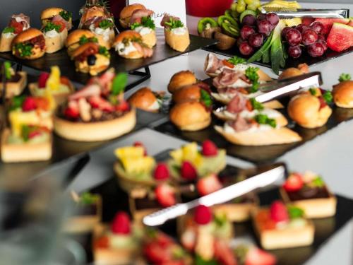 a bunch of different types of food on a table at Ibis Poznan Polnoc in Suchy Las