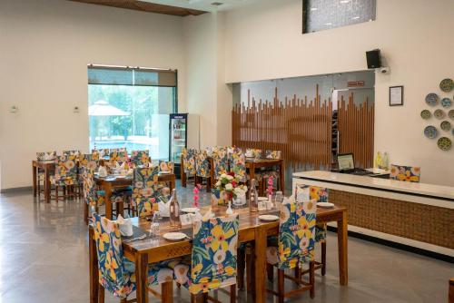 a dining room with tables and chairs and a counter at Bamboo Saa Mulberry Resort Pushkar in Pushkar