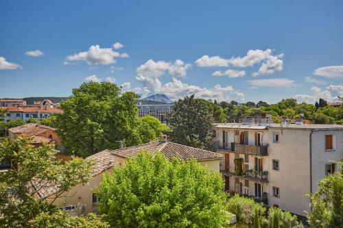 a view of a city with trees and buildings at Appart Hotel Odalys City Aix en Provence Les Floridianes in Aix-en-Provence
