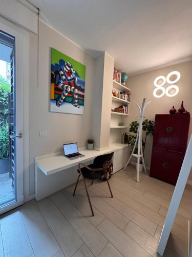 a room with a desk with a laptop on it at Suite privata con terrazza in Bologna