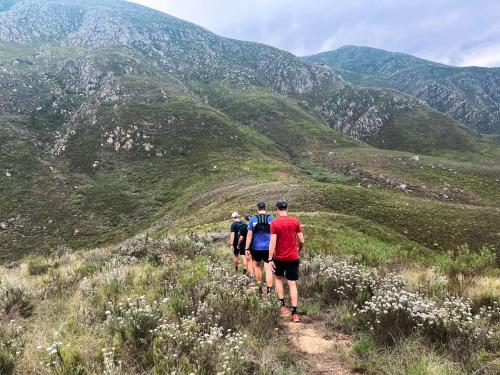 a group of people walking on a mountain trail at Pat Busch Mountain Reserve in Robertson