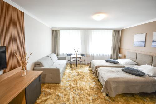 Postel nebo postele na pokoji v ubytování FOREST Family Resort Ustka