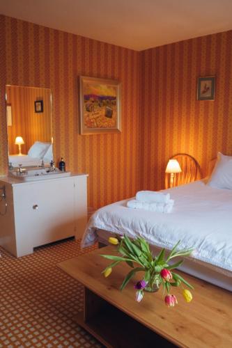 a hotel room with a bed and a sink at Ardtalnaig House, Loch Tay in Ardtalnaig