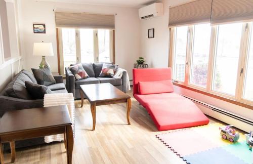 a living room with a couch and a table at Tranquil Retreats on Robinson in Moncton