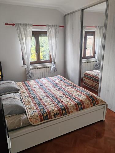 a bedroom with a bed and a mirror at Diego in Rijeka