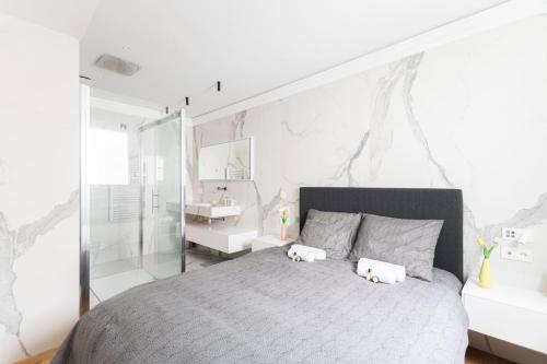 une chambre avec un grand lit et une salle de bain dans l'établissement GuestReady - Elegant Escape near Plaza Athénée, à Paris