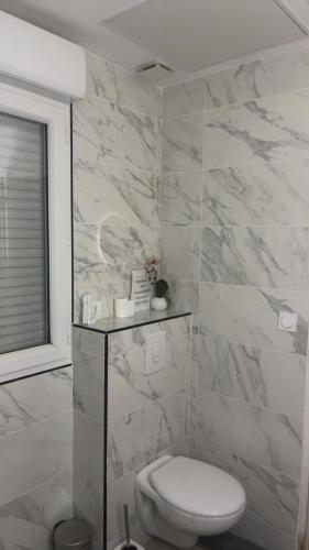 une salle de bain blanche avec toilettes et fenêtre dans l'établissement Love Paradise, à Le Rove