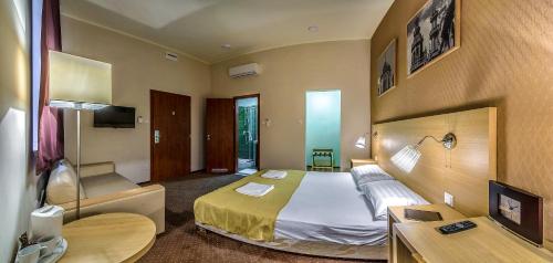 a hotel room with a bed and a desk at Budapest Citi Guesthouse - contactless self check in in Budapest