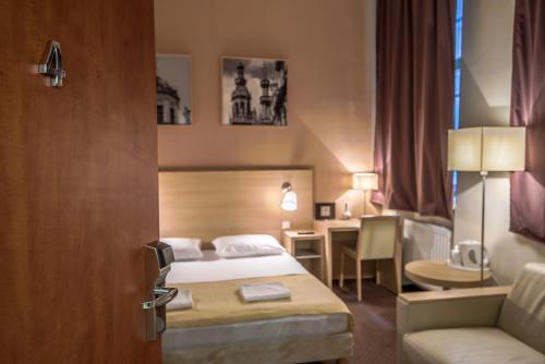 a hotel room with a bed and a desk at Budapest Citi Guesthouse - contactless self check in in Budapest