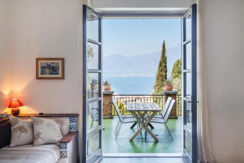 a living room with a glass door leading to a patio at Villa Maria Lake View,7 minuti a piedi dal centro, parcheggio privato in Torri del Benaco