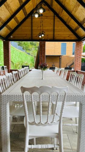 a white table with white chairs around it at Akhalsheni House in Batumi