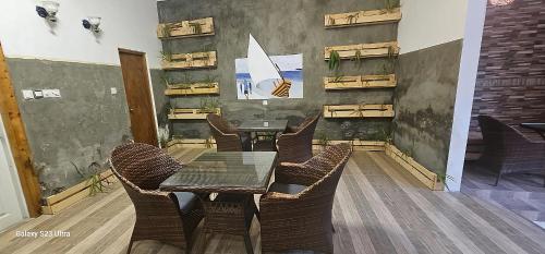 a dining room with a table and chairs at Dhontakuru Guest House in Ariyaddu