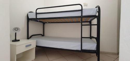 a bedroom with two bunk beds and a desk at Appartamenti Villa Miramare in Capoliveri