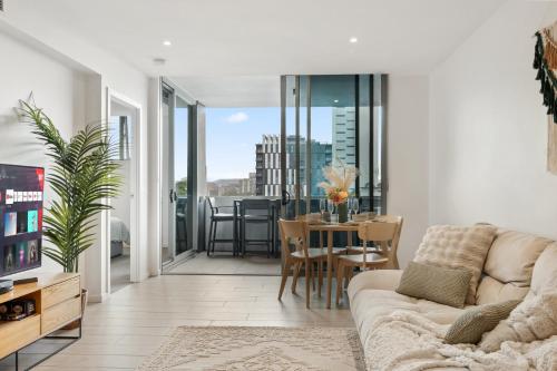 a living room with a couch and a table at Boho retreat near The Gabba with stunning views in Brisbane