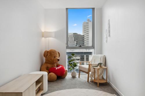 a teddy bear sitting in the corner of a room at Boho retreat near The Gabba with stunning views in Brisbane