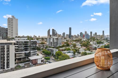 a view of a city from a balcony with a vase at Boho retreat near The Gabba with stunning views in Brisbane