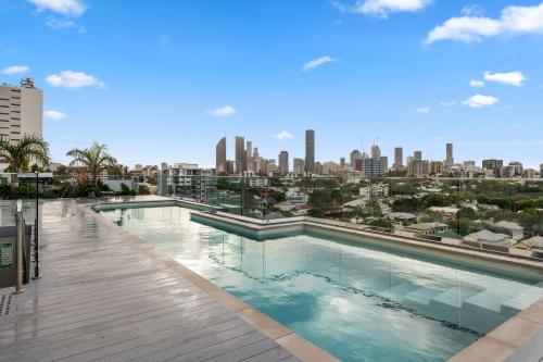 a swimming pool with a city skyline in the background at Boho retreat near The Gabba with stunning views in Brisbane