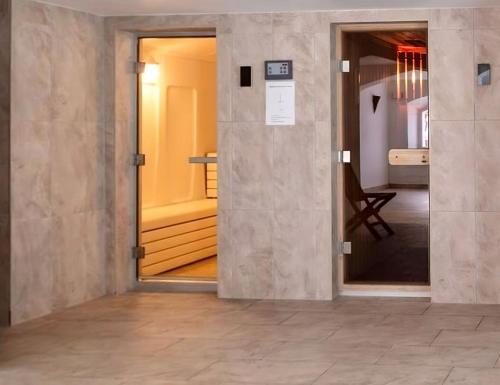 an open door in a room with a hallway at Luxury Apartment, Panoramic Mountain Views, 5 Star Spa Facilities - 3 Bedroom in Chateau-d'Oex