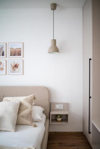 a bedroom with a bed and a pendant light at Geri Harmony Home in Zalaegerszeg