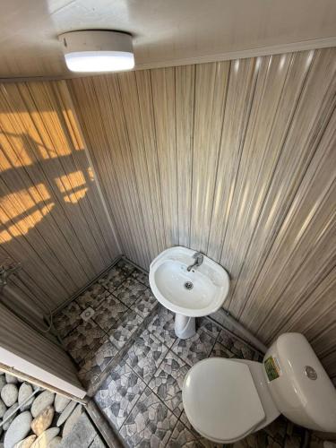 a bathroom with a sink and a toilet at Lovely home in Osh