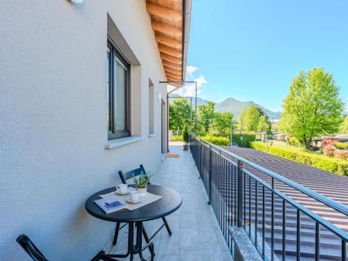 a patio with a table and chairs on a balcony at Apartment Camping Turisport-1 by Interhome in Dervio